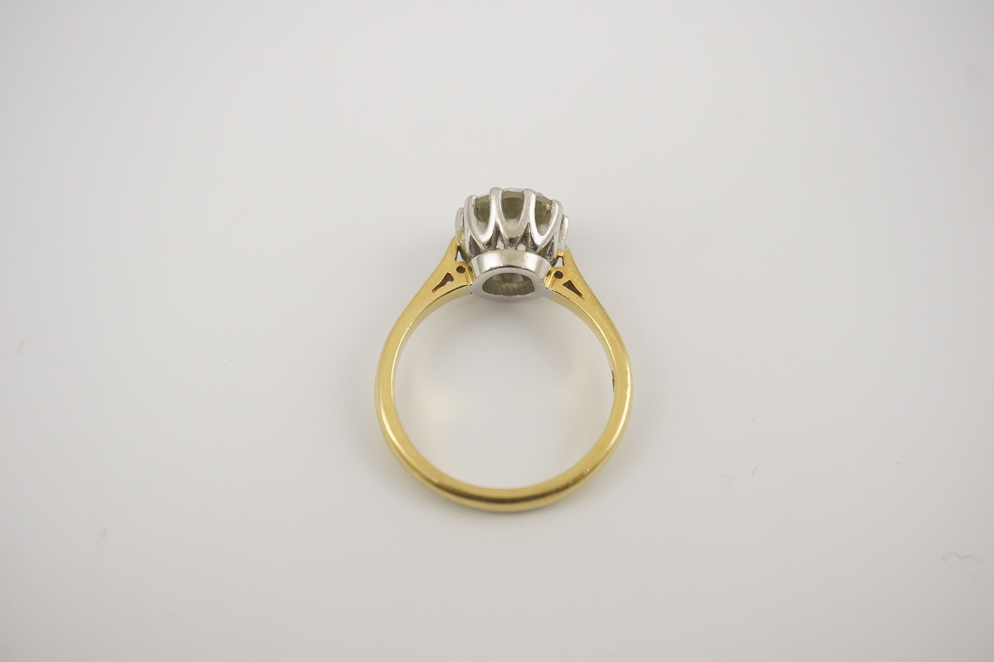 A modern 18ct gold and solitaire round cut diamond set ring